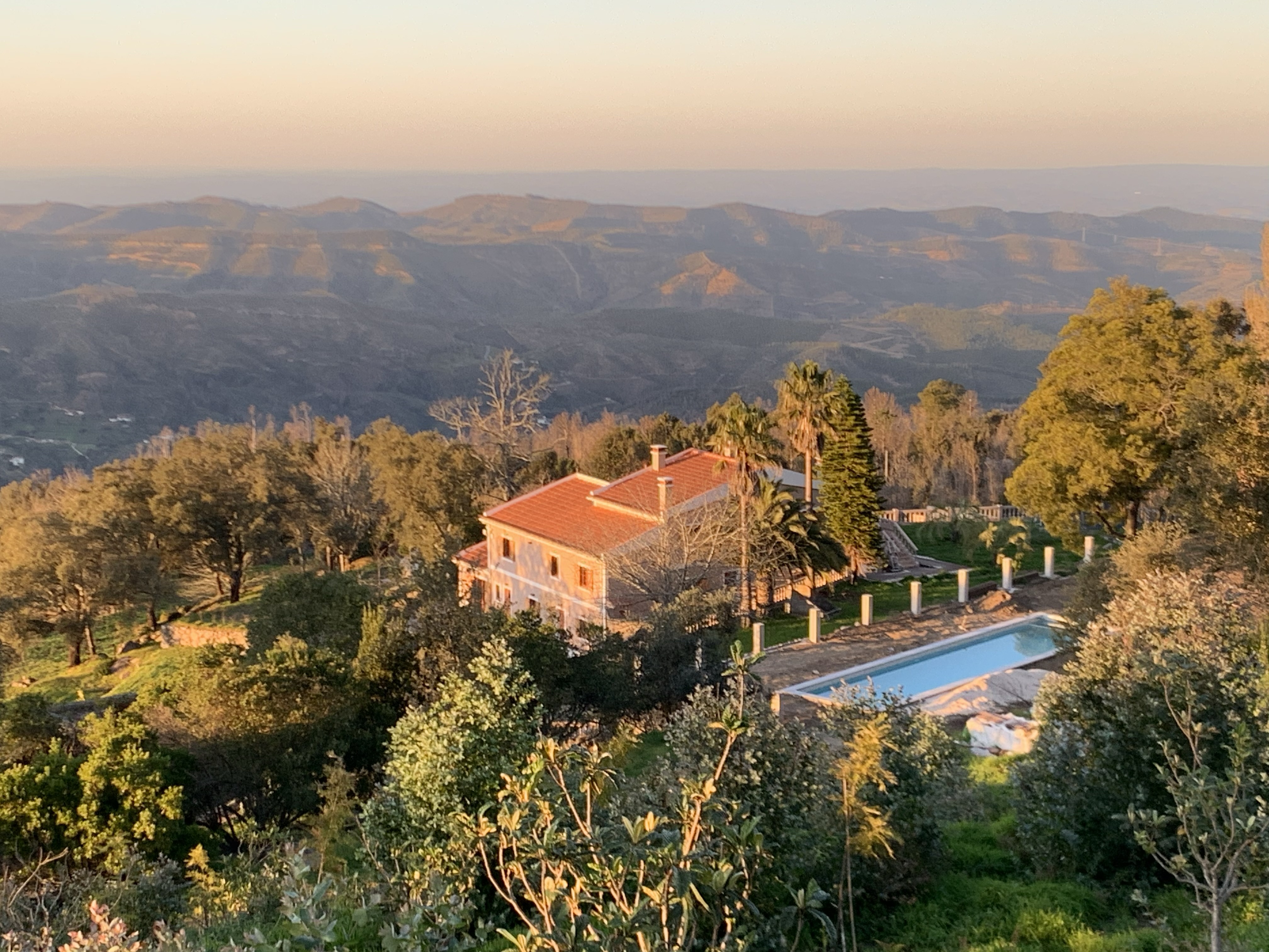 Bodhi Bhavan retreat house and pool overlooking the Monchique hills at golden hour